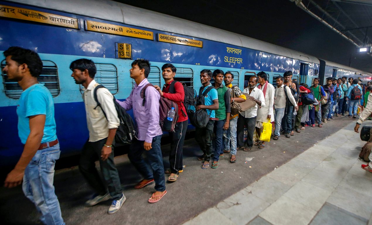 Ahmedabad: Migrant workers prepare to board the Sabarmati Express in view of protests which broke out over an alleged rape of a 14-month-old girl, in Ahmedabad, Monday, October 8, 2018.  (PTI Photo)  (PTI10_8_2018_000158B)