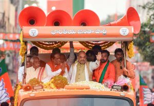 Musheerabad: BJP President Amit Shah waves at the crowd during a road show during an election campaign in favor of party leaders Dr K Laxman and Bandaru Dattatreya, in Musheerabad, Wednesday, Nov. 28, 2018. (PTI Photo) (PTI11_28_2018_000203B)