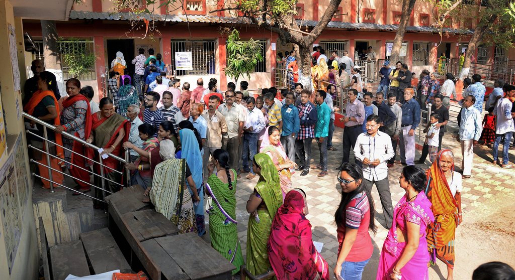 Raipur: Voters stand in a queue at a polling station to cast their votes for the 2nd phase of Assembly elections, in Raipur, Tuesday, Nov.20, 2018. (PTI Photo)(PTI11_20_2018_000040B)