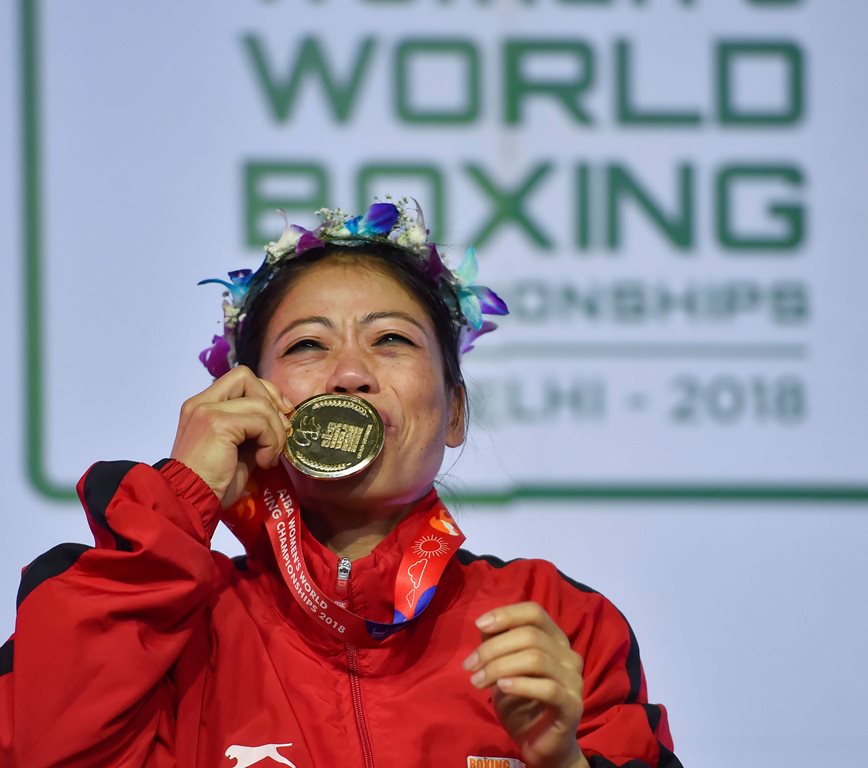 New Delhi: Indian boxer Mary Kom kisses her gold medal after winning the final match of women's light flyweight 45-48 kg against Ukraine's Hanna Okhota at AIBA Women's World Boxing Championships, in New Delhi, Saturday, Nov. 24, 2018. (PTI Photo/Ravi Choudhary) (PTI11_24_2018_000066)