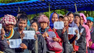 Kanhmun: Voters show their identity card as they stand in a queue at a polling station during the state Assembly elections, at Kanhmun, Mizoram, Wednesday, Nov.28, 2018. (PTI Photo) (PTI11_28_2018_000031)