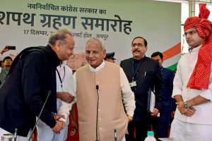 Jaipur: Rajasthan Governor Kalyan Singh shakes hands with newly sworn-in Chief Minister Ashok Gehlot as Deputy Chief Minister Sachin Pilot looks on, during the swearing-in-ceremony of Gehlot's government, in Jaipur, Monday, Dec. 17, 2018. (PTI Photo) (PTI12_17_2018_000128B)