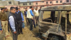 Bulandshahr: Policemen inspect vehicles set on fire by a mob yesterday during a protest over the alleged illegal slaughter of cattle, in Bulandshahr, Tuesday, Dec. 04, 2018. Four persons were arrested today after police lodged an FIR against over two dozen people for rioting and murder in connection with the violence, according to officials. (PTI Photo) (PTI12_4_2018_000040B)