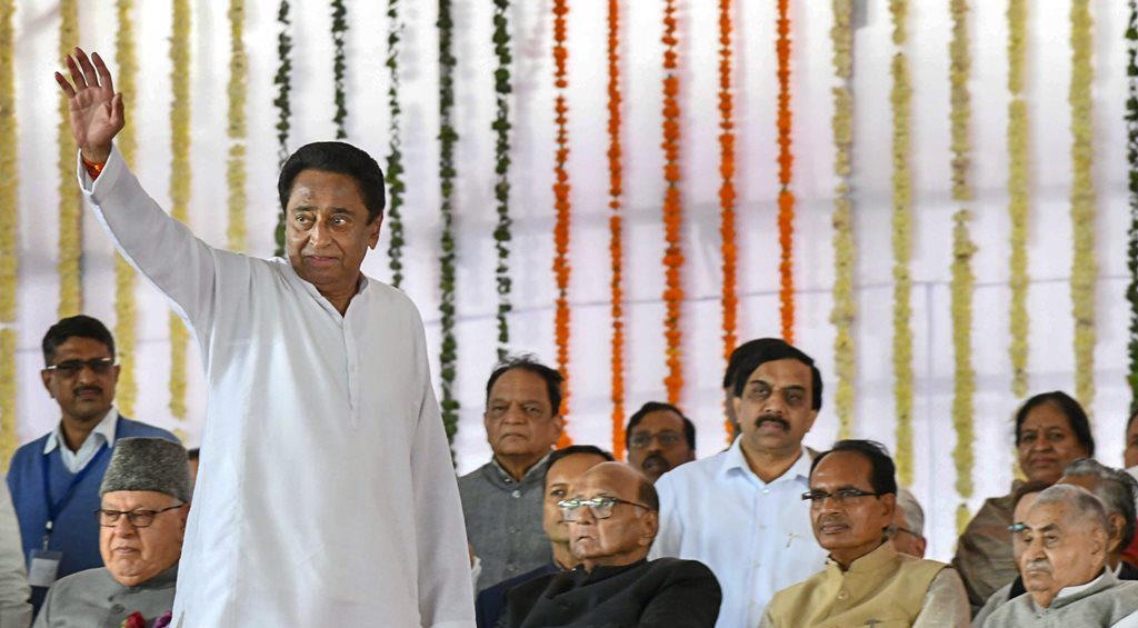 Bhopal: Newly-sworn in Madhya Pradesh Chief Minister Kamal Nath waves at the crowd during his swearing-in-ceremony, in Bhopal, Monday, Dec. 17, 2018. Also seen are NC chief Farooq Abdullah (L), NCP chief Sharad Pawar, former MP CM Shivraj Singh Chouhan and others. (PTI Photo) (PTI12_17_2018_000122)