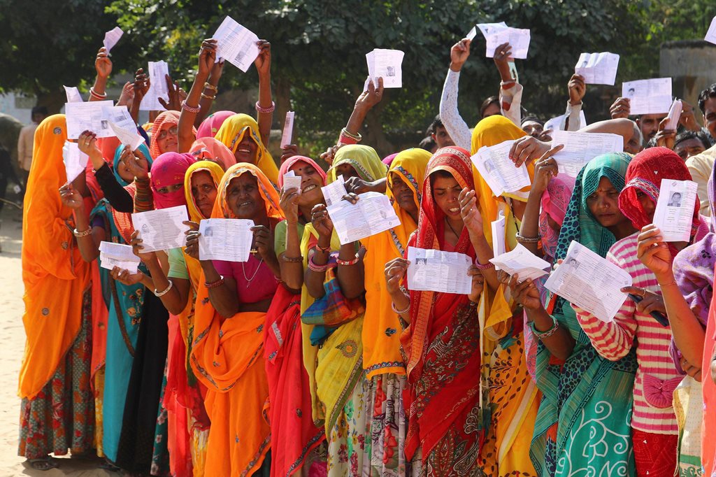 EDS PLS TAKE NOTE OF THIS PTI PICK OF THE DAY:::::::: Jaipur: Voters show their identity cards as they queue to cast their vote for the state Assembly elections, outside a polling station at Samred village of Jaipur district, Friday, Dec. 07, 2018. (PTI Photo)(PTI12_7_2018_000159B)(PTI12_7_2018_000187B)