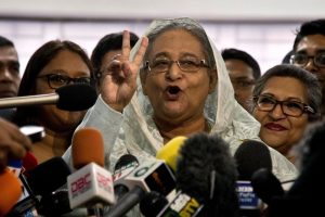 Dhaka : Bangladesh Prime Minister Sheikh Hasina flashes a victory sign as she speaks to the media persons after casting her vote in Dhaka, Bangladesh, Sunday, Dec. 30, 2018. Voting began Sunday in Bangladesh's contentious parliamentary elections, seen as a referendum on what critics call Prime Minister Sheikh Hasina's increasingly authoritarian rule.AP/PTI(AP12_30_2018_000035B)