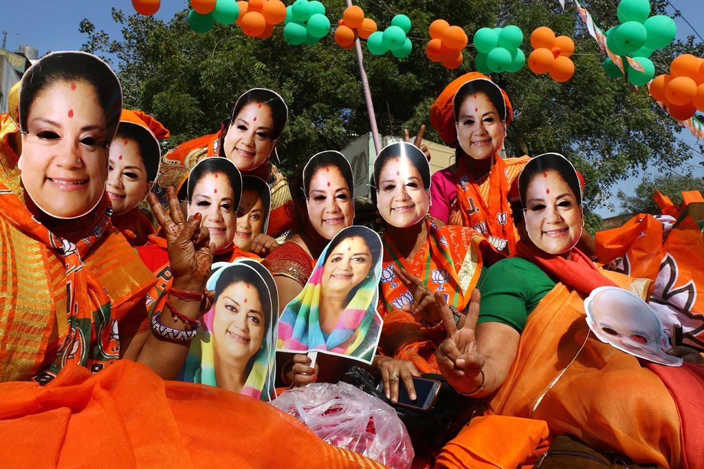 Ajmer: Bharatiya Janata Party (BJP) supporters wear masks of Rajasthan Chief Minister Vasundhara Raje at an election rally, in Ajmer, Wednesday, Dec. 05, 2018. (PTI Photo)(PTI12_5_2018_000049B)
