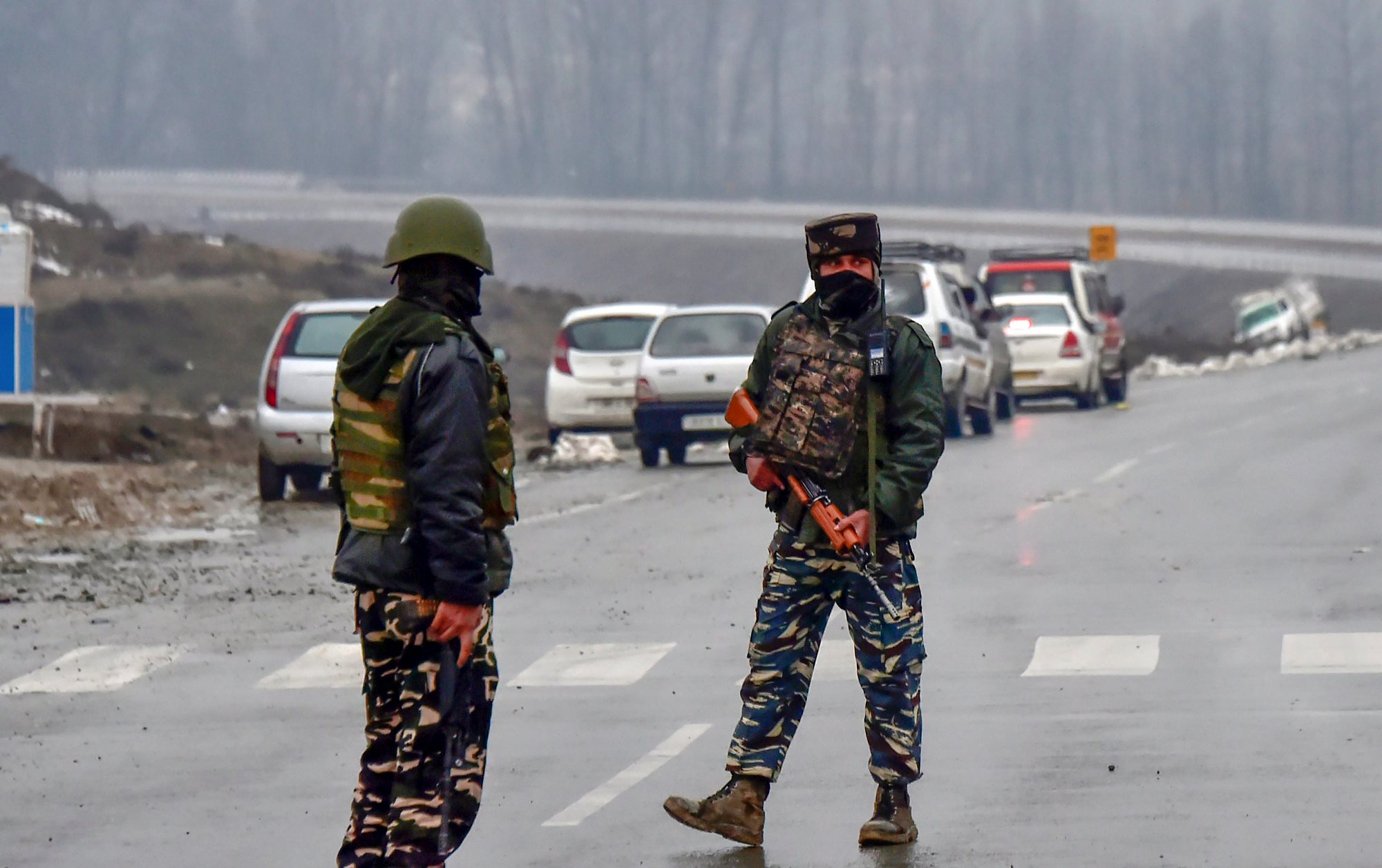 Awantipora: Army soldiers stand guard near the site of suicide bomb attack at Lathepora Awantipora in Pulwama district of south Kashmir, Thursday, February 14, 2019. At least 30 CRPF jawans were killed and dozens other injured when a CRPF convoy was attacked. (PTI Photo/S Irfan) (PTI2_14_2019_000155B)