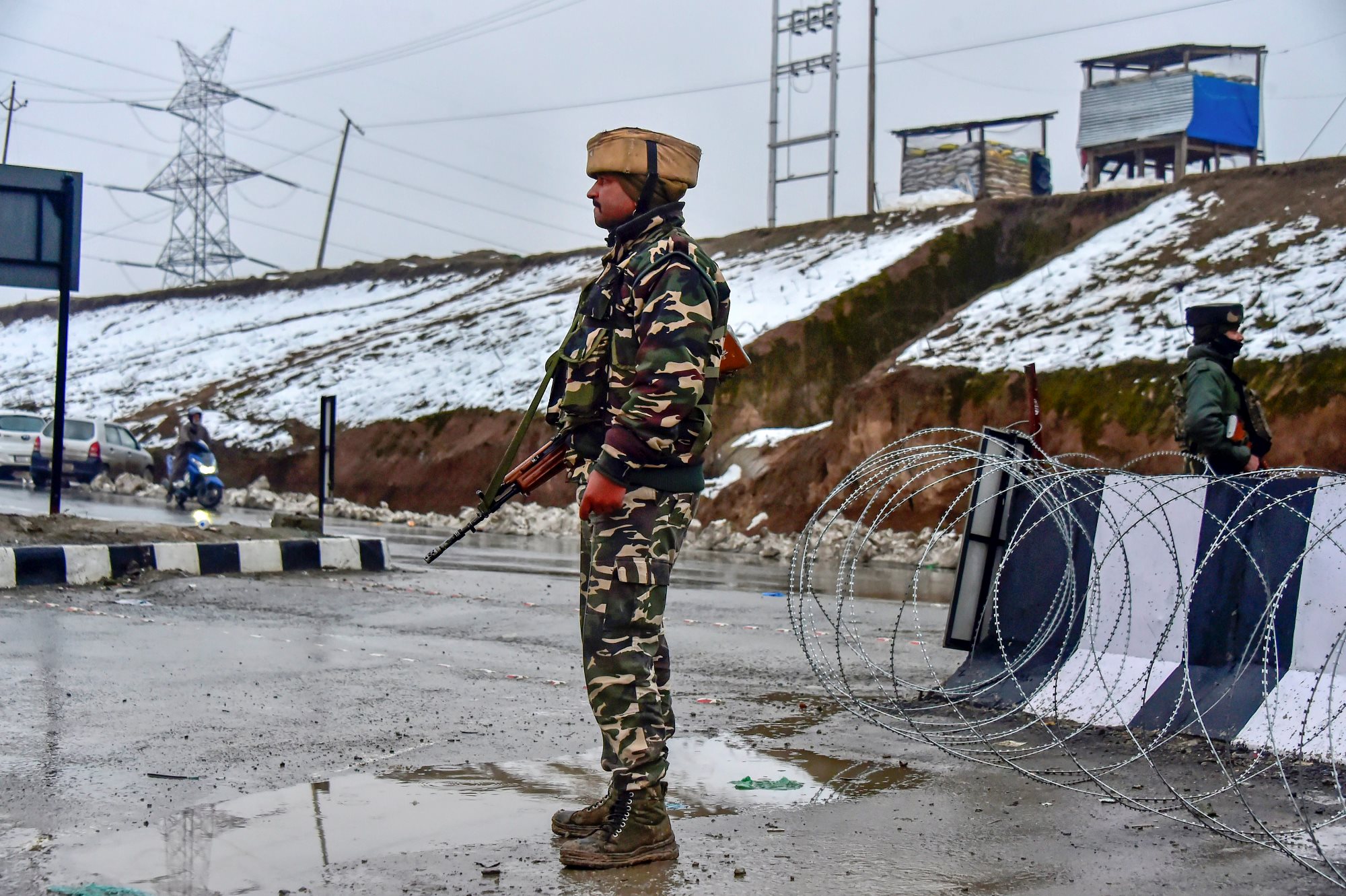 Awantipora: An army soldier stands guard near the site of the suicide bomb attack at Lathepora Awantipora in Pulwama district of south Kashmir, Thursday, February 14, 2019. At least 30 CRPF jawans were killed and dozens other injured when a CRPF convoy was attacked. (PTI Photo/S Irfan) (PTI2_14_2019_000154B)