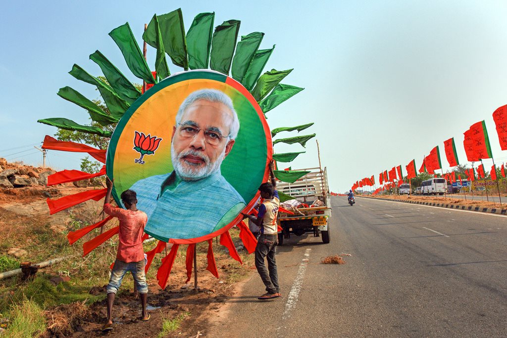 Kanyakumari: Workers place a huge portrait of Prime Minister Narendra Modi along a road ahead of his rally, in Kanyakumari, Thursday, Feb. 28, 2019. (PTI Photo)(PTI2_28_2019_000137B)