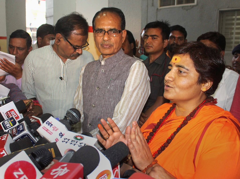 Bhopal: BJP candidate for Bhopal Lok Sabha seat Sadhvi Pragya Singh Thakur, with BJP vice president Shivraj Singh Chouhan, addresses a press conference at the party's state headquarters in Bhopal, Wednesday, April 17, 2019. BJP has fielded Thakur, an accused in the 2008 Malegaon blasts, as its candidate against Congress leader Digvijay Singh. (PTI Photo) (PTI4_17_2019_000160B)
