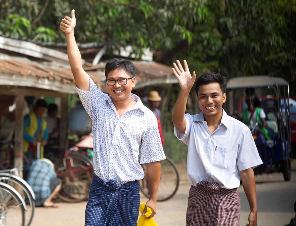 Yangon: Reuters journalists Wa Lone, left, and Kyaw She Oo wave as they walk out from Insein Prison after being released in Yangon, Myanmar Tuesday, May 7, 2019. The chief of the prison said two Reuters journalists who were imprisoned for breaking the country's Officials Secrets Act have been released. AP/PTI(AP5_7_2019_000022B)