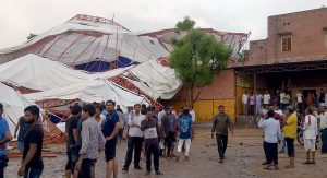 Barmer: Panic stricken people after a pandal fell during a Ram Katha due to storm in Jasol village of Barmer district of Rajasthan, Sunday, June 23, 2019. At least 14 people reportedly dead in the mishap. (PTI Photo)