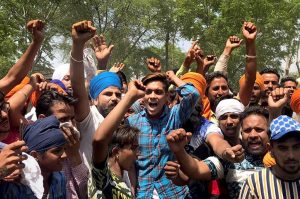 Sangrur: People stage a protest against the district administration and the state government over delay in the rescue of Fatehvir Singh, a two-year-old child who died after falling in a 150-foot-deep unused borewell, in Sangrur district, Tuesday, June 11, 2019. (PTI Photo) (PTI6_11_2019_000080B)