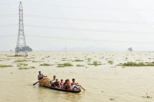 Morigaon: Villagers relocate to a safer place from their flood-affected village following monsoon rains, in Morigoan, Friday, July 19, 2019. (PTI Photo) (PTI7_19_2019_000228B)