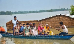 Muzaffarpur: Flood-affected villagers use a boat to take a patient to hospital from their inundated village, at Mithan Sharay in Muzaffarpur, Tuesday, July 23, 2019. (PTI Photo) (PTI7_23_2019_000233B)