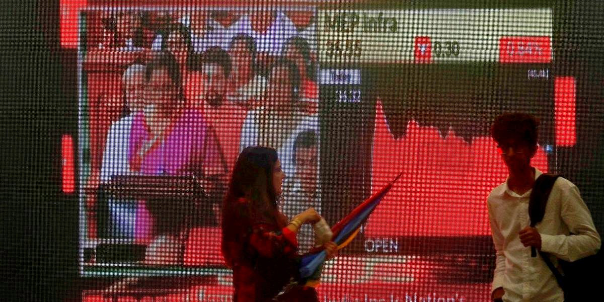 People walk as a telecast of India's Finance Minister Nirmala Sitharaman presenting the budget is displayed inside the Bombay Stock Exchange (BSE) building in Mumbai, July 5, 2019. Image: Reuters/Francis Mascarenhas