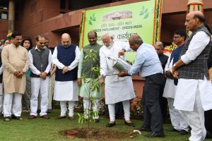 The Prime Minister, Shri Narendra Modi planting the sapling with other dignitaries at the tree plantation drive organised by the Lok Sabha Secretariat, at Parliament House Premises, in New Delhi on July 26, 2019.