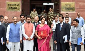 New Delhi: Finance Minister Nirmala Sitharaman with MoS Anurag Thakur and others outside the North Block ahead of the presentation of Union Budget 2019-20 at Parliament, in New Delhi, Friday, July 05, 2019. (PTI Photo/Ravi Choudhary)(PTI7_5_2019_000014B)