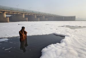 A Hindu devotee takes a ritual dip in the polluted Yamuna river in New Delhi March 21, 2010. The Earth is literally covered in water, but more than a billion people lack access to clean water for drinking or sanitation as most water is salty or dirty. March 22 is World Water Day. REUTERS/Danish Siddiqui (ENVIRONMENT)