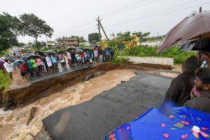 Mysore: Locals stranded as a part of the road collapsed after water from Kabini reservoir in HD Kote was released following heavy monsoon rainfall, in Mysore, Thursday, Aug 8, 2019. (PTI Photo) (PTI8_8_2019_000214B)