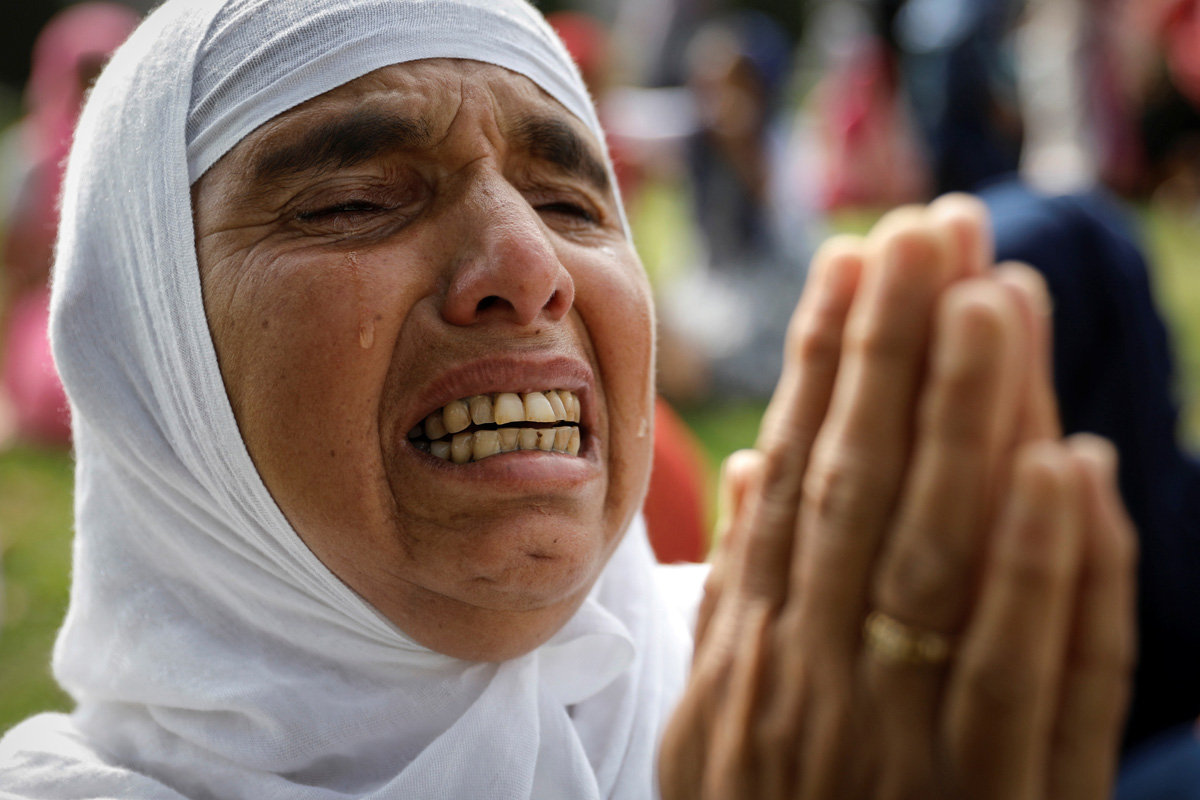 A Kashmiri woman cries during the Eid-al-Adha prayers at a mosque during restrictions after the scrapping of the special constitutional status for Kashmir by the Indian government, in Srinagar, August 12, 2019. REUTERS/Danish Siddiqui - RC12AA342540