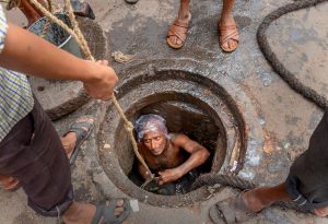**EDS: FILE PHOTO** Kolkata: In this ug 10, 2018 file photo, a Municipal Corporation worker enters a manhole for sewage cleaning at Mahatma Gandhi Road, in Kolkata. Slamming the government authorities for not providing protective gear like masks and oxygen cylinders to people engaged in manual scavenging and manhole cleaning, the Supreme Court on Wednesday, Sept. 18, 2019 said this is the "most inhuman" way to treat a human being. (PTI Photo)(PTI9_18_2019_000169B)