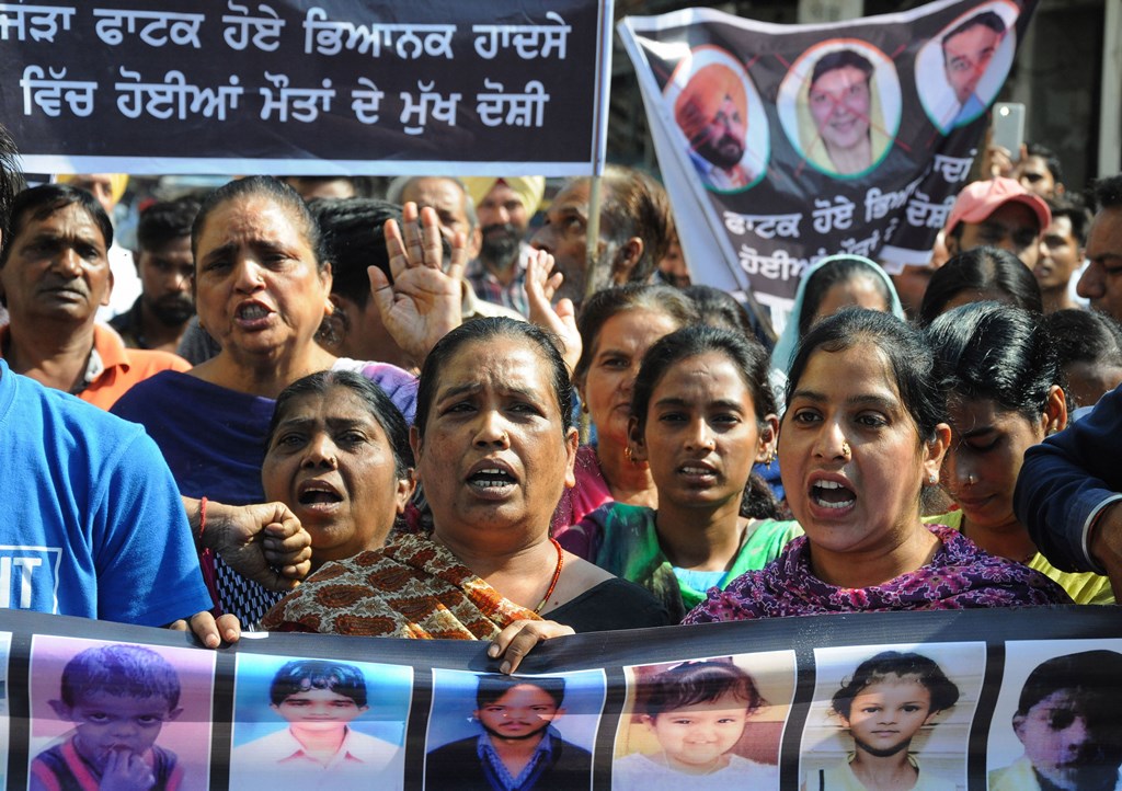 Amritsar: Family members of victims, who died in the train tragedy on Dussehra last year, protest against the state government demanding justice and claiming the promised jobs at Joda Phatak, in Amritsar, Tuesday, Oct. 8, 2019. At least 61 people were killed and over 70 sustained injuries in the tragic incident near Joda Phatak in Amritsar on October 19 last year. (PTI Photo) (PTI10_8_2019_000096B)