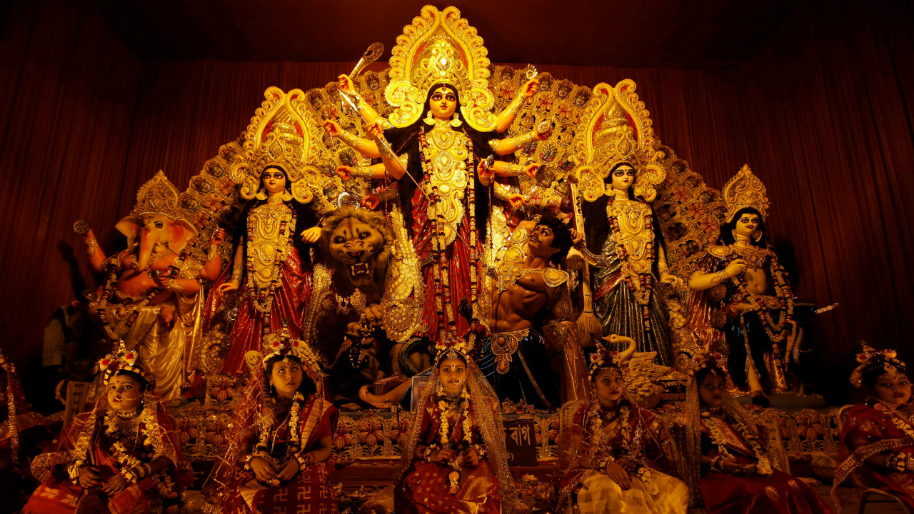 Young girls dressed as Kumari sit in front of the idols of Hindu goddess Durga before being worshipped as part of a ritual during the Durga Puja festival celebrations at a pandal in Kolkata (Image: Reuters)
