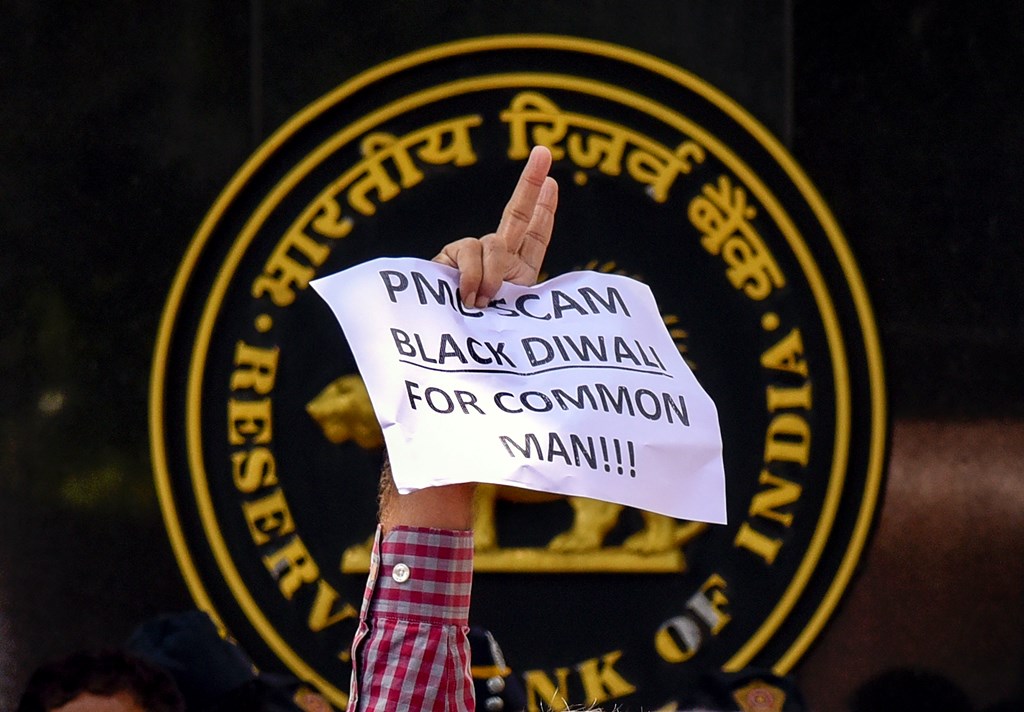 Mumbai: A depositor of Punjab and Maharashtra Cooperative (PMC) bank displays a placard during a protest over the bank's crisis, outside the Reserve Bank of India building, in Mumbai, Tuesday, Oct 1, 2019. (PTI Photo) (PTI10_1_2019_000116B)