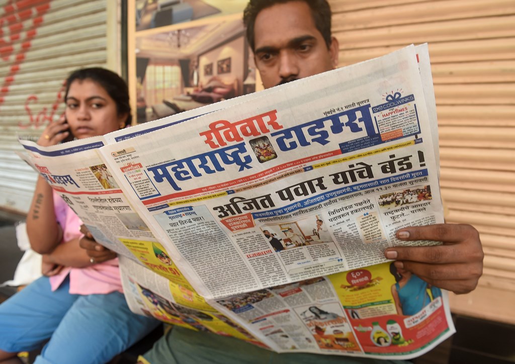 Mumbai: A local reads newspaper fronted with headlines on Maharashtra government formation, in Mumbai, Sunday, Nov. 24, 2019. (PTI Photo/Mitesh Bhuvad)(PTI11_24_2019_000036B)