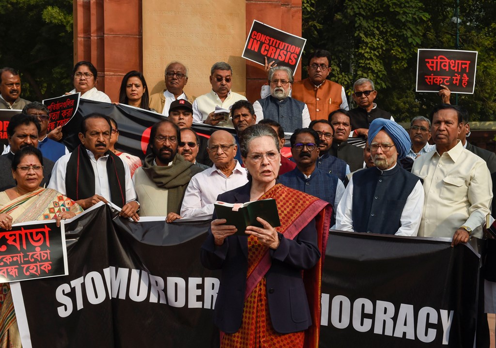 New Delhi: Congress President Sonia Gandhi reads out the Preamble to the Constitution as party leaders Manmohan Singh, Rahul Gandhi and other opposition leaders look on during a protest, at Parliament premises in New Delhi, Tuesday, Nov. 26, 2019. (PTI Photo/Kamal Singh) (PTI11_26_2019_000085B)