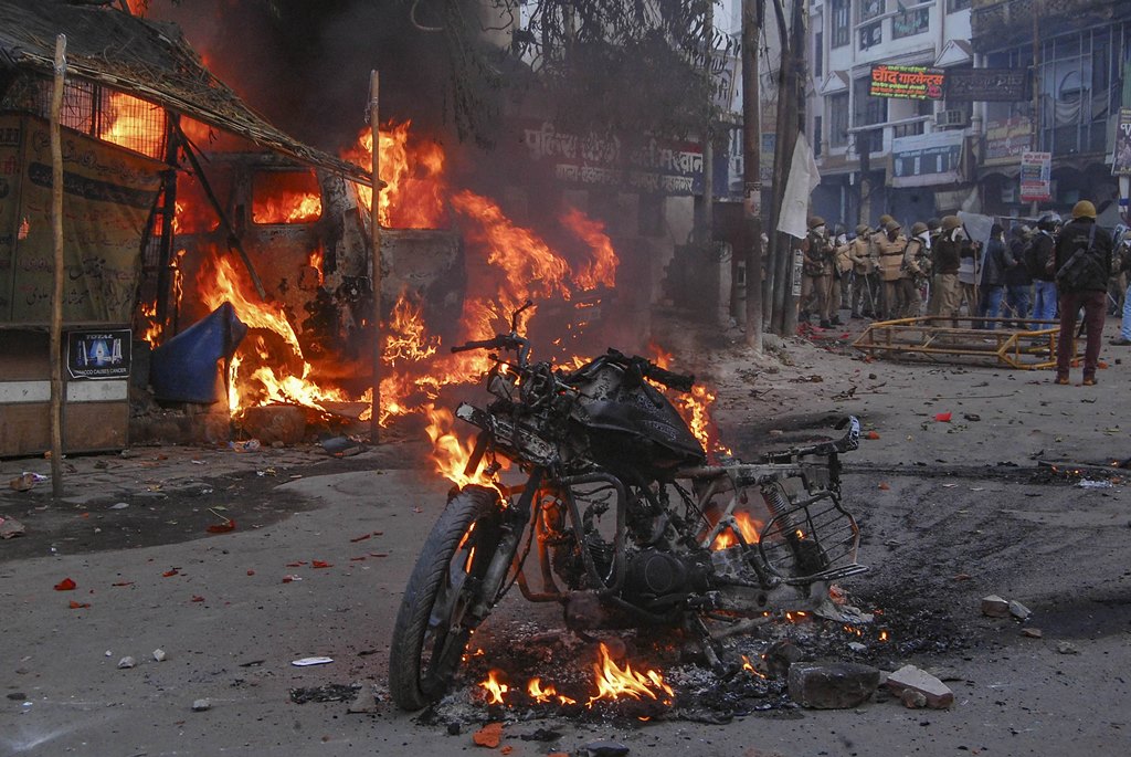 Kanpur: A vehicle torched allegedly by protestors during a demonstration against the Citizenship Amendment Act (CAA), in Kanpur, Saturday, Dec.21, 2019. (PTI Photo)