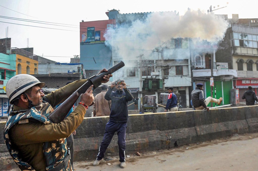 Patna: Police personnel fire tear gas shells at protesters during a rally against NRC and amended Citizenship Act that turned violent, at Phulwarisharif, in Patna,Saturday,Dec 21,2019.( PTI Photo)(PTI12_21_2019_000242B)