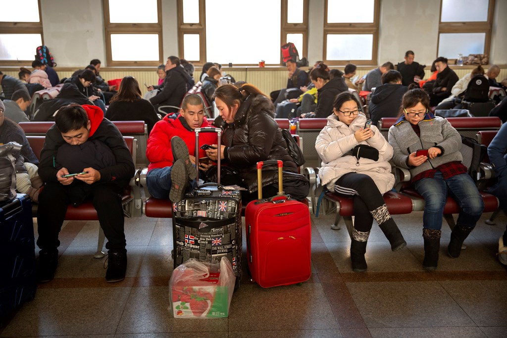 Beijing: Travelers sit in waiting room at the Beijing Railway Station in Beijing, Friday, Jan. 17, 2020. As the Lunar New Year approached, Chinese travelers flocked to train stations and airports Friday to take part in a nationwide ritual: the world's biggest annual human migration. AP/PTI(AP1_17_2020_000034B)