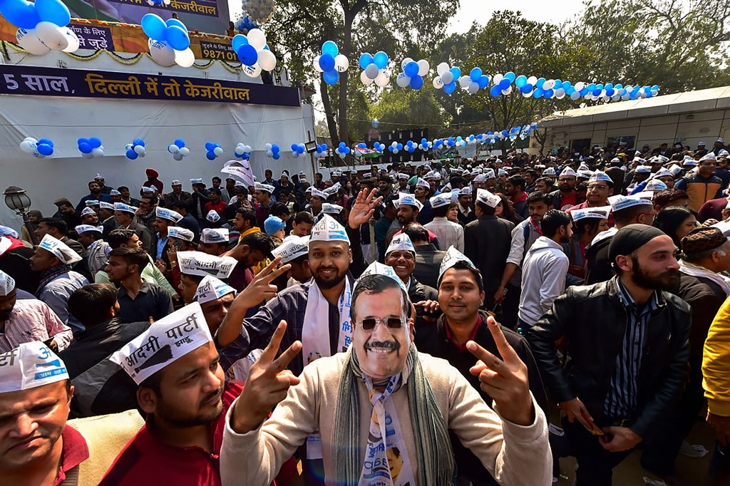 New Delhi: An Aam Aadmi Party worker, dressed as party chief Arvind Kejriwal, celebrates along with others the party's success in the Delhi Assembly polls, at party headquarters in New Delhi, Tuesday, Feb. 11, 2020. (PTI Photo/Manvender Vashist)   (PTI2_11_2020_000086B)