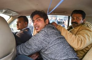 New Delhi: Police take away an unidentified person after he allegedly opened fire in the Shaheen Bagh area of New Delhi, Saturday, Feb. 1, 2020. Many anti-CAA protestors have been staging a peaceful demostration in the area for since Dec. 15, 2019. (PTI Photo/Arun Sharma) (PTI2_1_2020_000214B)