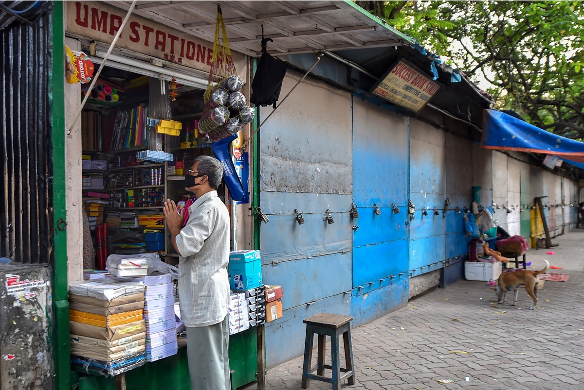 Kolkata: A book seller offers prayers while closing his shop for next few days before lockdown in the wake of coronavirus pandemic, at a book market in Kolkata, Monday, March 23, 2020. (PTI Photo/Swapan Mahapatra)(PTI23-03-2020 000157B)