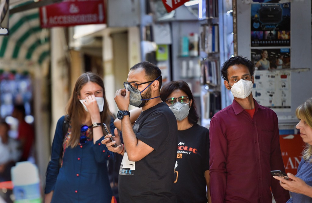 New Delhi: People wear protective masks to contain the spread of coronavirus (COVID-19) pandemic, at Khan Market in New Delhi, Monday, March 16, 2020. The number of cases in India has risen to 110. (PTI Photo/Ravi Choudhary)(PTI16-03-2020_000101B)