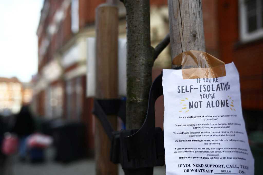 A sign is seen down a London street regarding self isolation as the spread of the coronavirus disease (COVID-19) continues. London, Britain March 21, 2020 REUTERS/Hannah Mckay