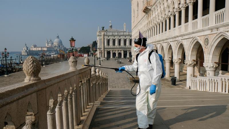 A worker sanitises Ponte della Paglia bridge on St. Mark's square as a measure to fight against the coronavirus contagion in Venice, Italy [Manuel Silverstri/Reuters]