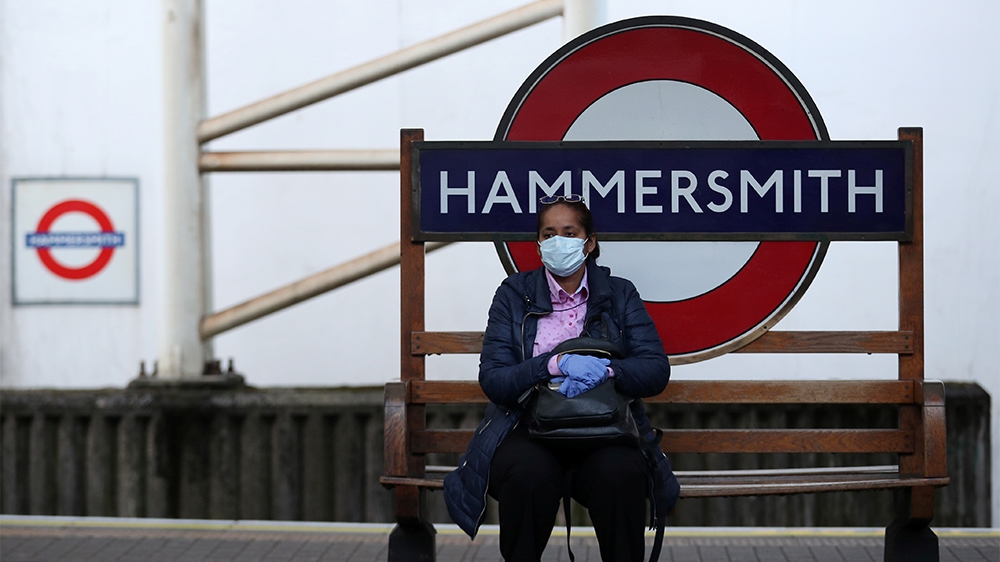 A commuter wearing a protective face mask at Hammersmith underground station as the spread of the coronavirus disease (COVID-19) continues, in London, the United Kingdom, on March 24, 2020 [Hannah McKay/Reuters]