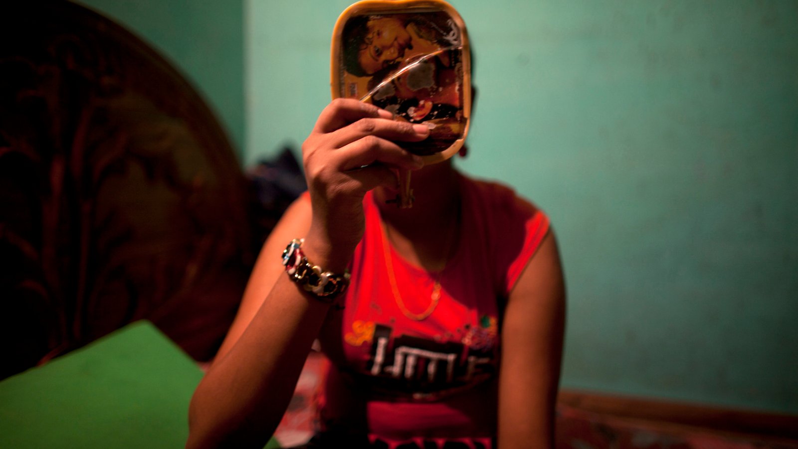 Twelve-year-old prostitute Mukti applies makeup before serving a customer inside her small room at a brothel in Faridpur, located in central Bangladesh February 22, 2012. REUTERS/Andrew Biraj