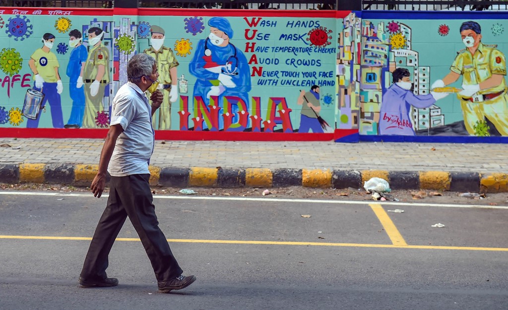 New Delhi: A man walks past wall mural on coronavirus awareness, during the ongoing COVID-19 nationwide lockdown, at Barakhamba Road police station in New Delhi, Thursday, May 7, 2020. (PTI Photo/Manvender Vashist)(PTI07-05-2020_000256B)