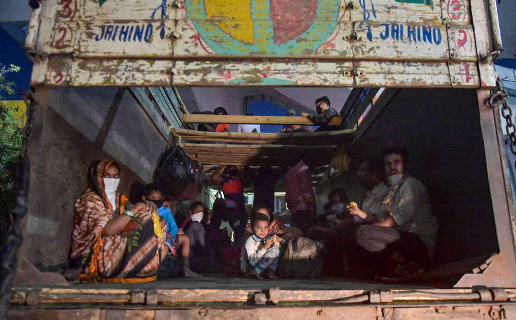 Thane: Migrants from various northern states board a truck at the Mumbai-Nashik highway to reach their native places, during the ongoing COVID-19 nationwide lockdown, in Thane, Monday, May 11, 2020. (PTI Photo/Mitesh Bhuvad)(PTI11-05-2020_000276B)