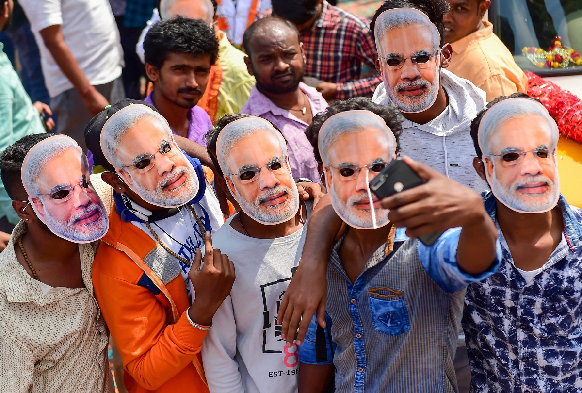 Bengaluru: BJP workers wear masks of Prime Minister Narendra Modi as they arrive in support of Bengaluru Central candidate PC Mohan, as he filed his nomination papers ahead of Lok Sabha Election 2019, in Bengaluru, Friday, March 22, 2019. (PTI Photo/Shailendra Bhojak) (PTI3_22_2019_000078B)