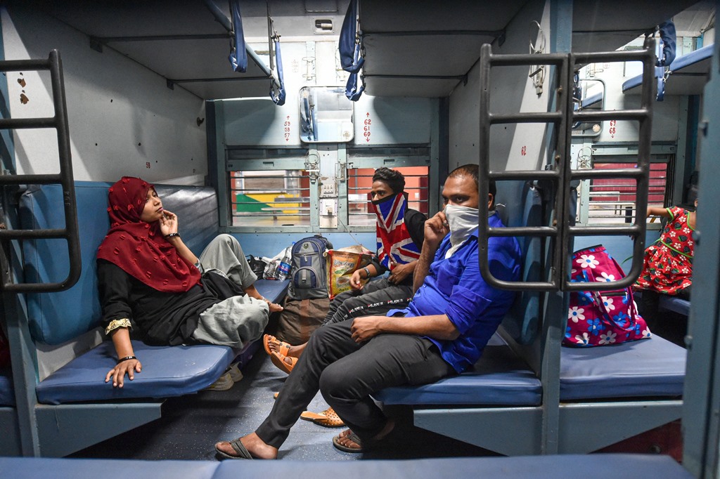 Lucknow: Passengers onboard a train at Charbagh railway station during COVID-19 lockdown 5.0, in Lucknow, Monday, June 1, 2020. Railways started its operation with 200 new trains from Monday, the first day of the 'Unlock 1' phase of the nationwide lockdown imposed to limit the spread of the Covid-19 coronavirus. (PTI Photo/ Nand Kumar)(PTI01-06-2020_000350B)