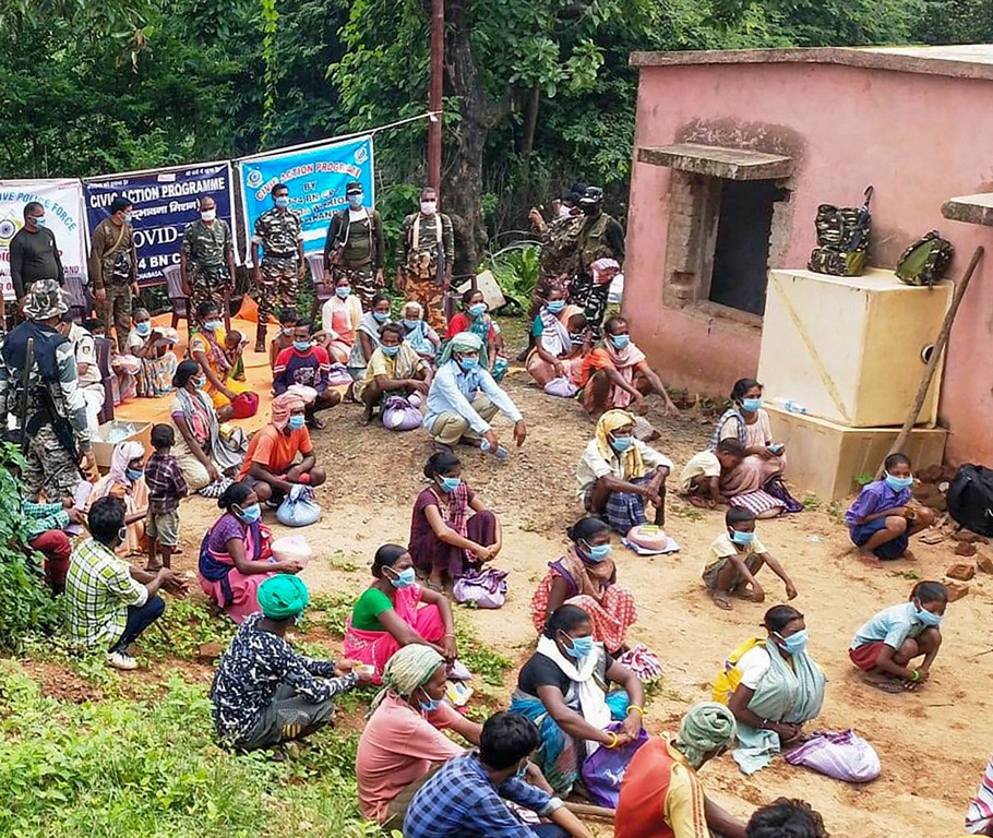 Chaibasa: People wait to collect ration and medicines, distributed by the Central Reserve Police Force (CRPF) personnel, at Gudri block in Chaibasa district, Saturday, June 27, 2020. PTI Photo)(PTI27-06-2020 000236B)