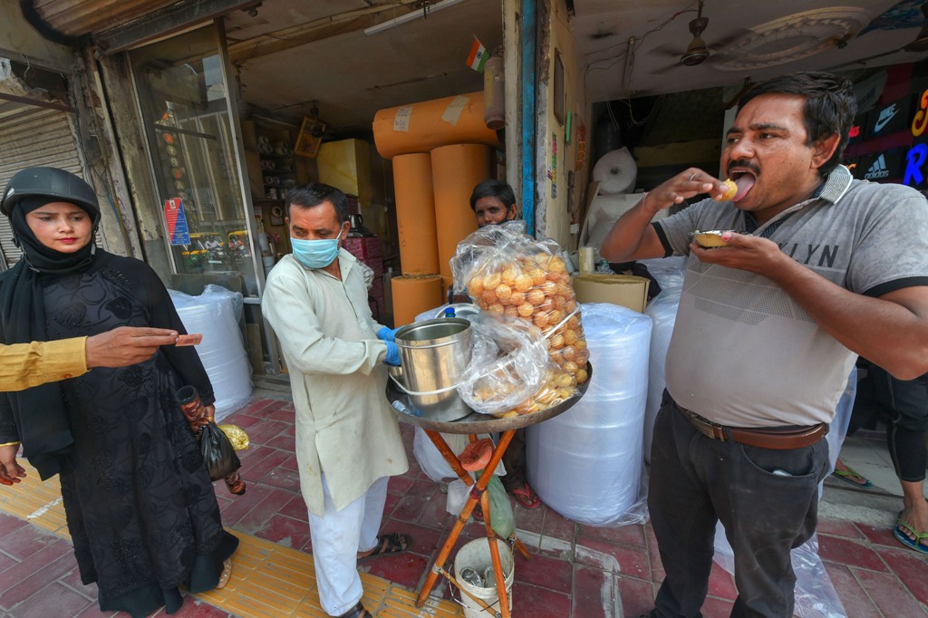 New Delhi: People eat at a Golgappa stall after the authority eased restrictions, during COVID-19 lockdown 5.0, in New Delhi, Monday, June 1, 2020. (PTI Photo/ Shahbaz Khan)