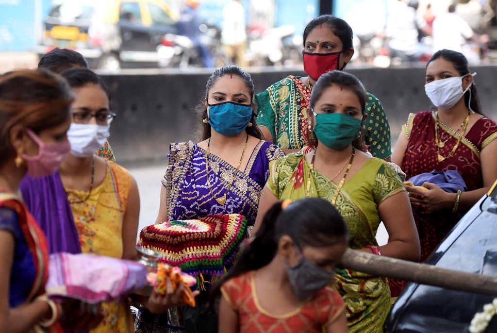 Mumbai: Hindu married women, wearing face masks amid concerns over COVID-19 outbreak, wait to perform rituals around a banyan tree on the occasion of the Vat Savitri (also called Vat Purnima), near Dharavi slum in Mumbai, Friday, June 5, 2020.(PTI Photo/Kunal Patil) (PTI05-06-2020 000053B)